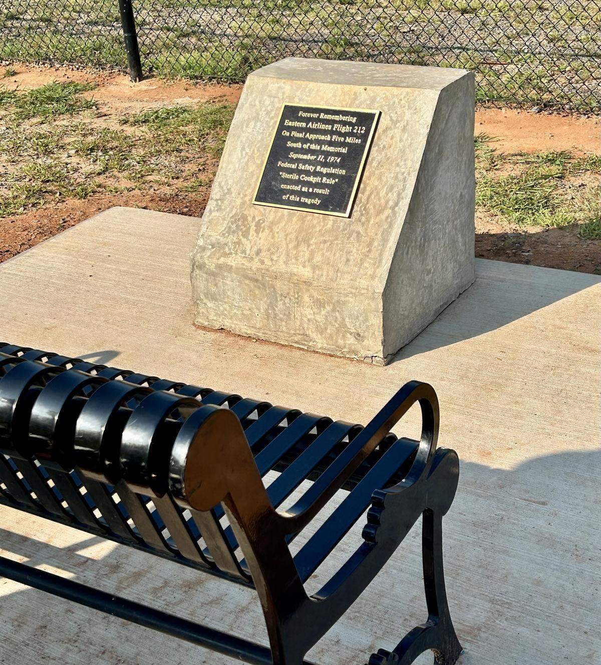 Eastern Flight 212, which crashed in 1974 in Charlotte and killed 72 people, is now memorialized at Charlotte’s Airport Overlook park. A metal bench faces an airport runway. Directly in front of it is a historical monument, explaining the doomed flight and its significance.
