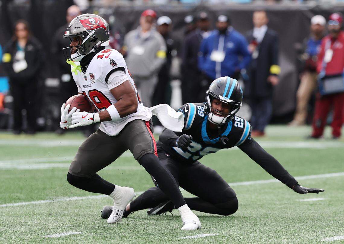 Tampa Bay Buccaneers Kameron Johnson carries the ball against Carolina Panthers Akayleb Evans during a 2025 game at Bank of America Stadium