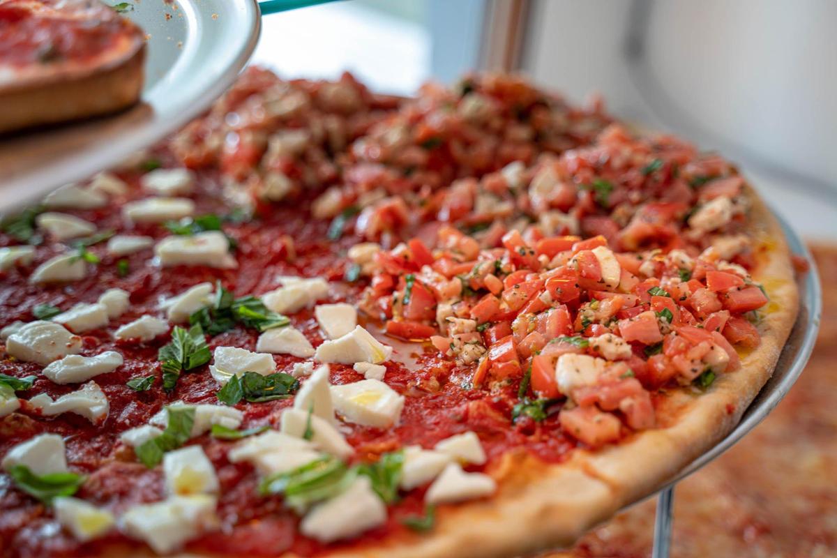 A split pizza at Sal’s with half Bruschetta: buffalo mozzerella, tomato, garlic, basil, and half Margherita: buffalo mozerella, basil, olive oil drizzle.