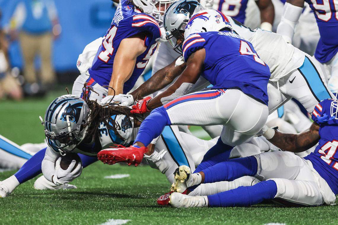 Panthers running back D’Onta Foreman, bottom left, scrambles his way out a scrum during the game against the Bills at Bank of America Stadium on Friday, August 26, 2022 in Charlotte, NC.