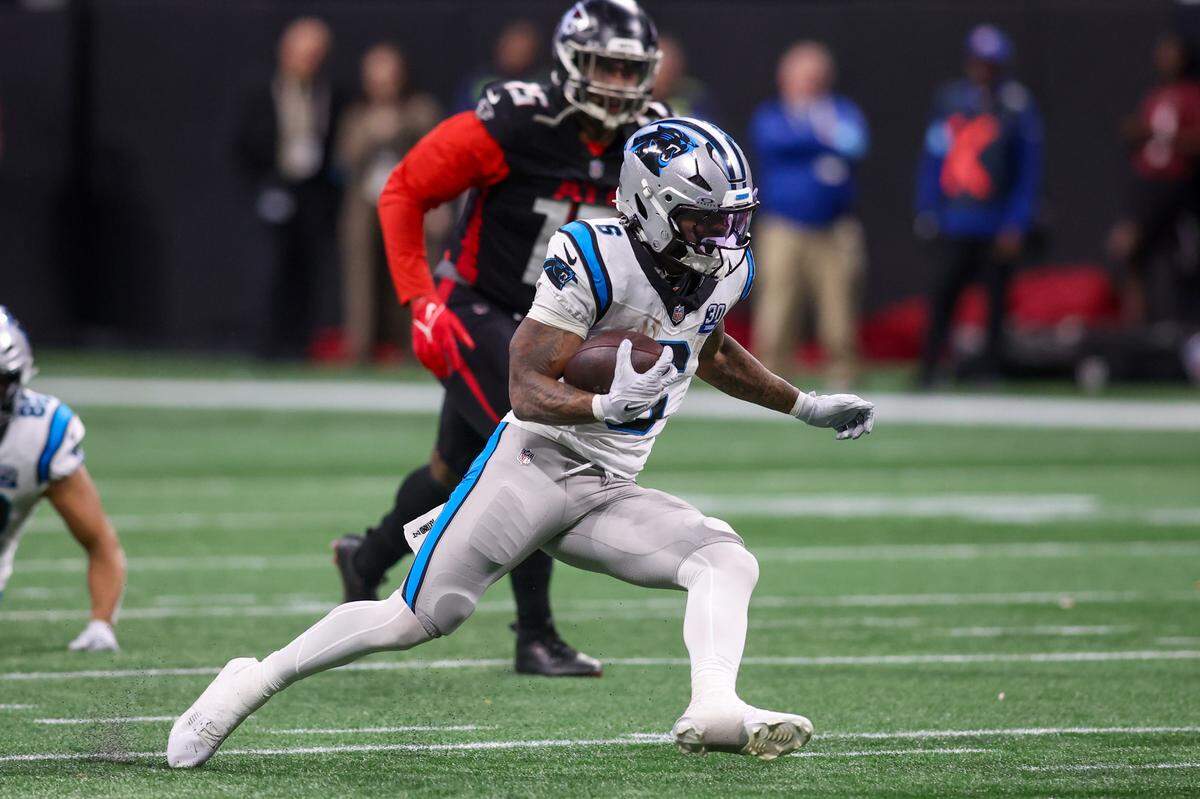 Carolina Panthers running back Miles Sanders (6) runs the ball against the Atlanta Falcons in Sunday’s overtime at Mercedes-Benz Stadium.