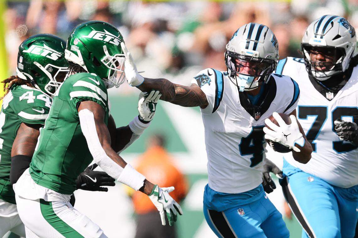 Carolina Panthers wide receiver Tetairoa McMillan (4) stiff arms New York Jets cornerback Sauce Gardner (1) in the second quarter of Sunday’s game in New Jersey.