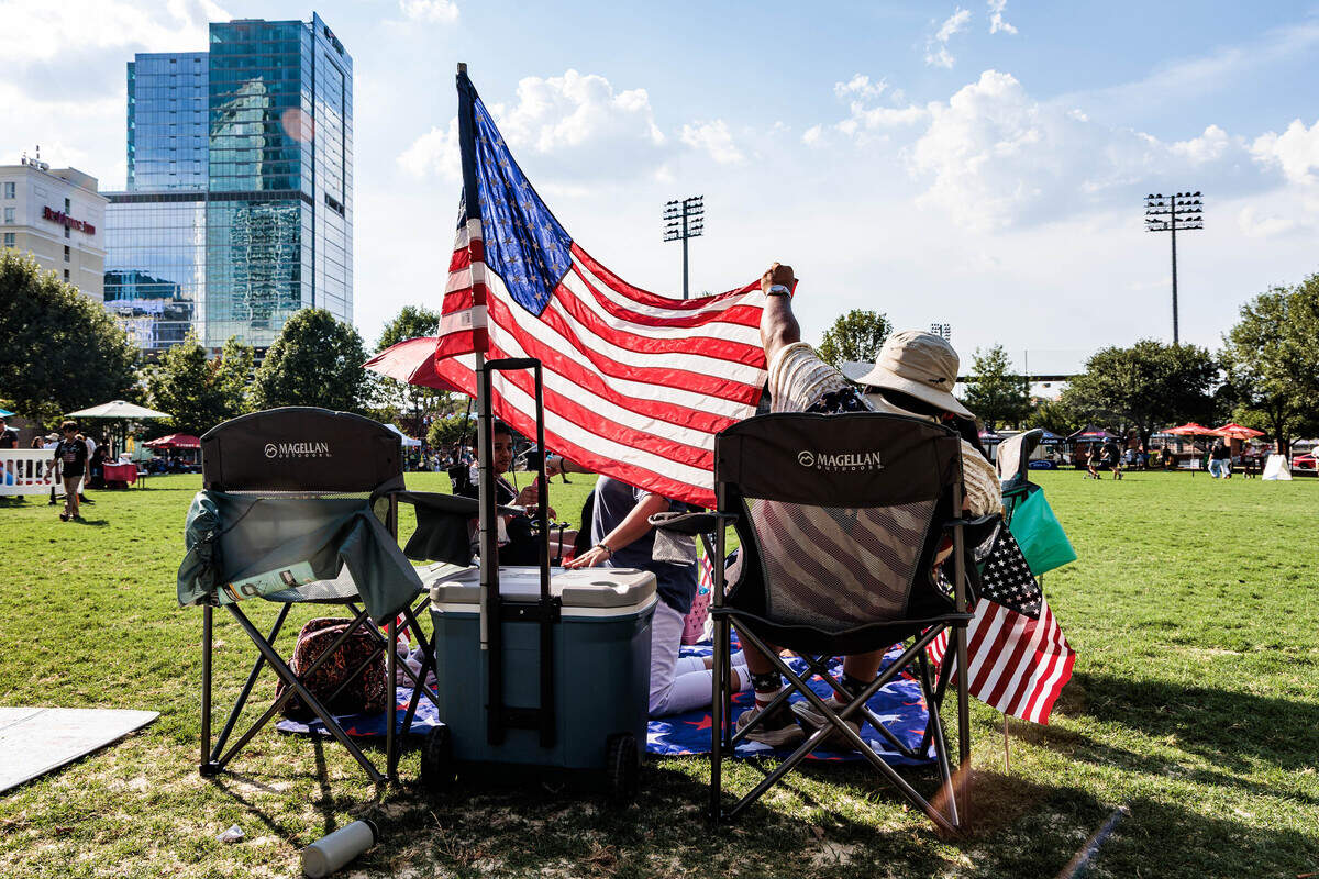Don Martinez fixes his American flag on Saturday July 4, 2026 in Romare Bearden Park.