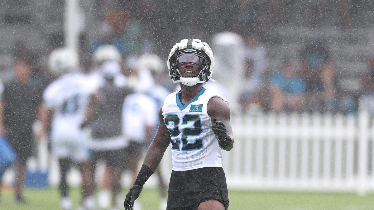 Carolina Panthers safety Jammie Robinson smiles as he stands in the rain during practice on Thursday, July 25, 2024.