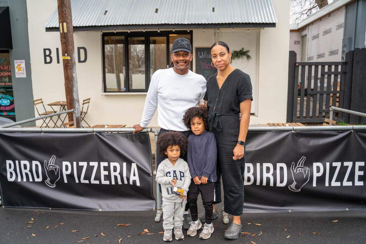 Kerrel and Nkem Thompson, owners of Bird Pizzeria in Charlotte's Optimist Park neighborhood, photographed with their sons in 2021.