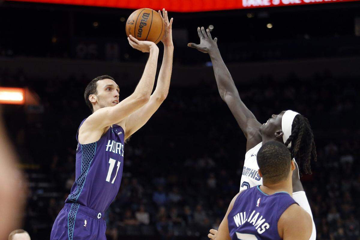 Charlotte Hornets forward Aleksej Pokusevski (17) shoots as Memphis Grizzlies forward Wenyen Gabriel (32) defends during the second half at FedExForum.