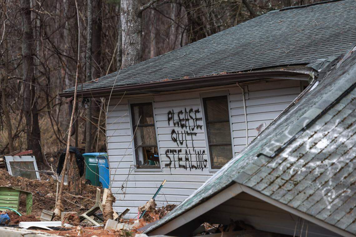 A hand-written message on an exterior wall of Sabrina Mills’ flood-ruined home pleads with looters to stay away.