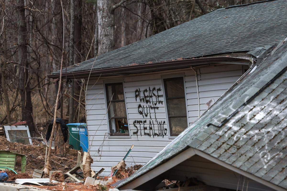 A hand-written plea on an exterior wall of Sabrina Mills flood-ruined home pleads with looters to stay away.
