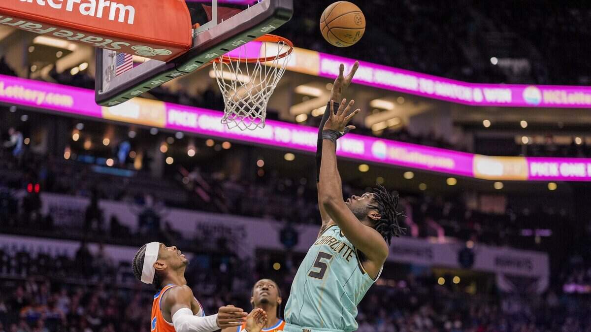 Charlotte Hornets center Mark Williams (5) takes a shot against Oklahoma City Thunder guard Shai Gilgeous-Alexander (2) during the first quarter at Spectrum Center. 
