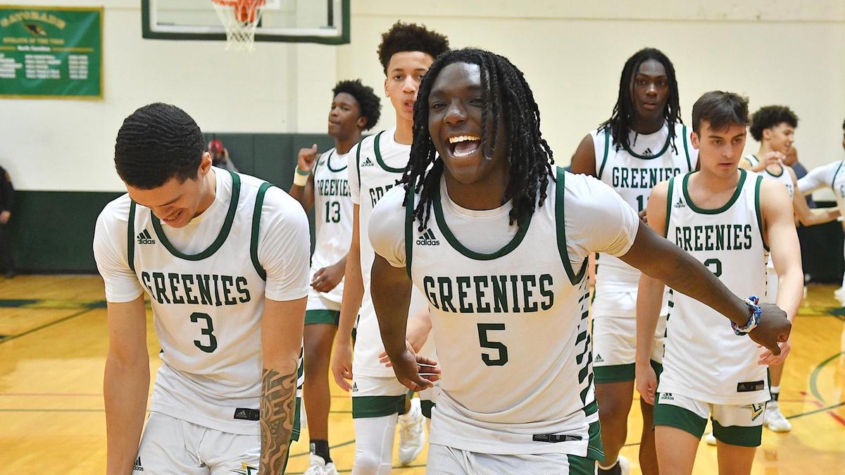 Christ School’s Jamari Briggs (5) and Bryson Cokley (3) celebrate after defeating Providence Day for the NCISAA State Basketball Championship.