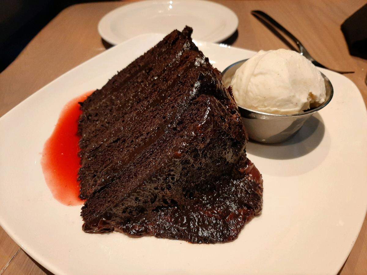 The big daddy chocolate cake is served with ice cream at Firebirds Wood Fired Grill, open now in Fort Mill across from Brayden.