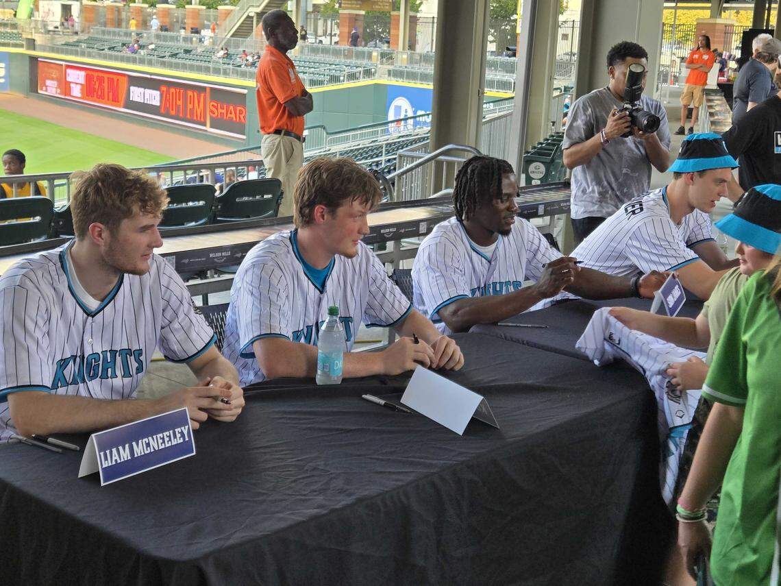 Charlotte Hornets rookies Kon Knueppel, Liam McNeeley, Sion James and Ryan Kalkbrenner sign autographs for fans at Truist Field on Friday night.