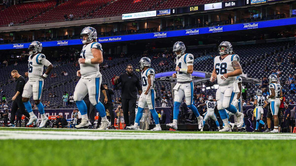 Panthers quarterbacks and offensive linemen run onto the field for warm-ups before their game at the Houston Texans last season. Line and quarterback are spots Carolina needs to upgrade in 2022.