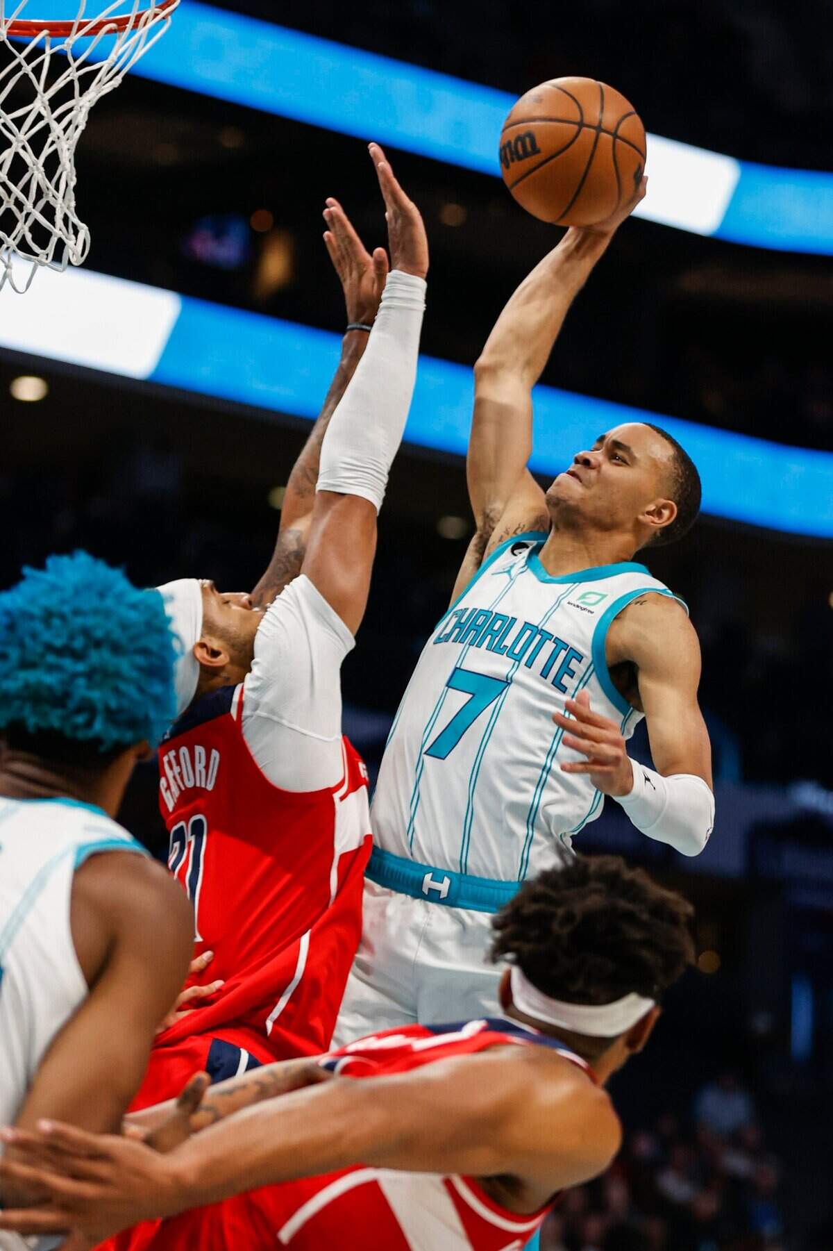 Charlotte Hornets guard Bryce McGowens, right, shoots over Washington Wizards center Daniel Gafford during the second half of an NBA basketball game in Charlotte, N.C., Friday, Dec. 2, 2022. Charlotte won 117-116. (AP Photo/Nell Redmond)