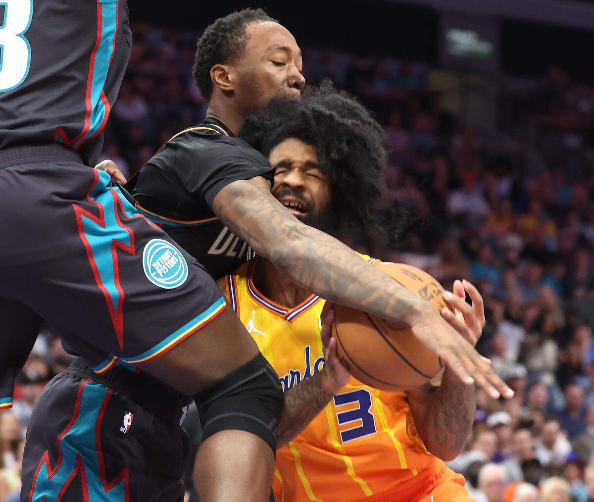 Charlotte Hornets guard Coby White, right, is fouled by Detroit Pistons forward Ron Holland II. Detroit played more physically than Charlotte in the fourth quarter and won, 118-100.