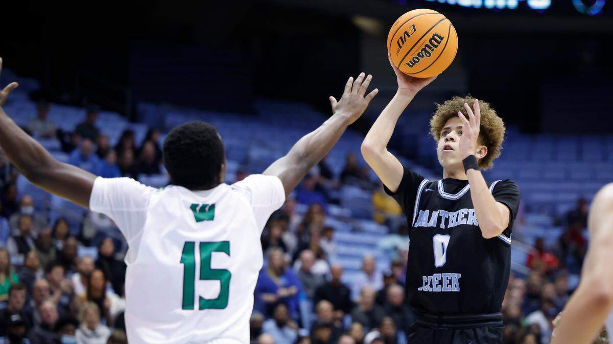 Panther Creek’s Jordan Snell (0) shoots over Weddington’s Berni Tah (15) during the NCHSAA 4A basketball state championship game at the Smith Center in Chapel Hill, N.C., Saturday, March 12, 2022. Weddington beat Panther Creek 76-58.