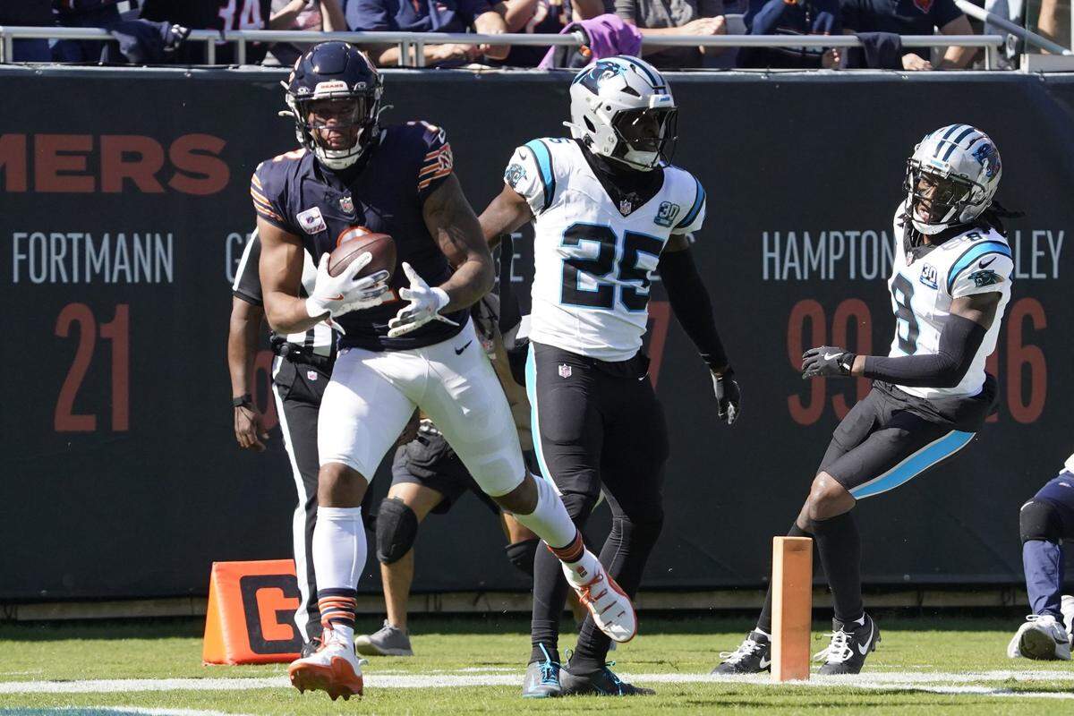 Oct 6, 2024; Chicago, Illinois, USA; Chicago Bears wide receiver DJ Moore (2) catches a touchdown pass as Carolina Panthers safety Xavier Woods (25) defends him during the first half at Soldier Field. Mandatory Credit: David Banks-Imagn Images
