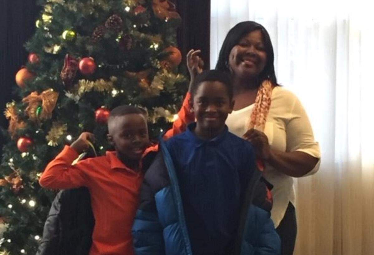 Joy Graham (right) and her nephews-turned-sons Kinrick and Jahkai, enjoy some Christmas traditions together like decorating the tree on Christmas Eve.