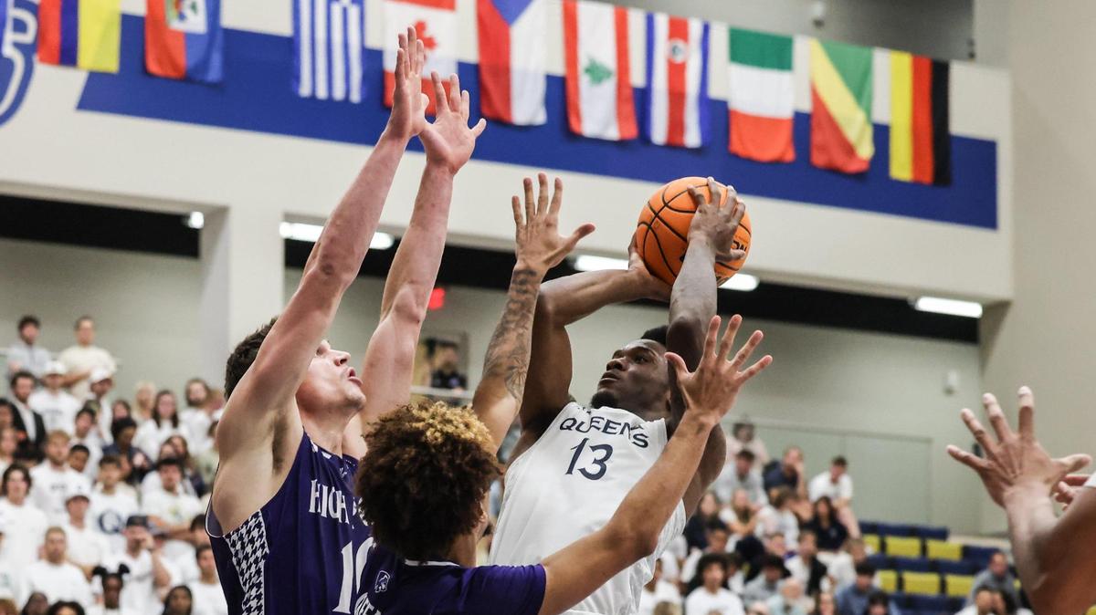 Queens’ Deyton Albury, right, shoots past a block by High Point’s Cade Potter at Queens University in Charlotte, N.C., on Tuesday, November 14, 2023.