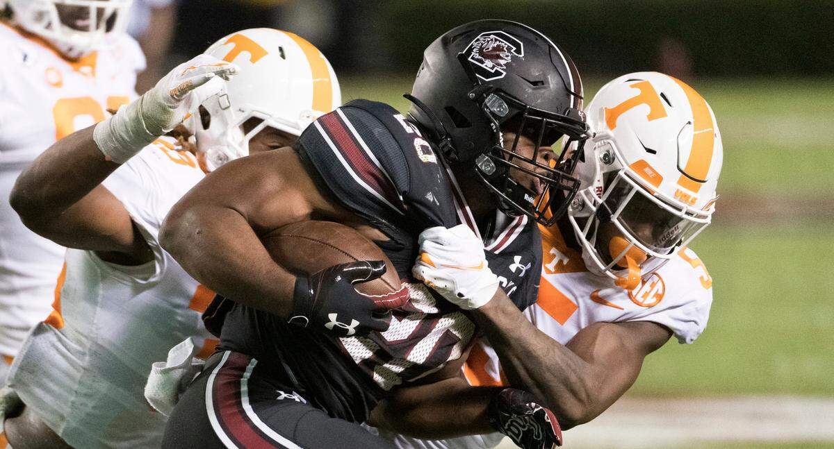 South Carolina running back Kevin Harris (20) carries against Tennessee’s Kenneth George Jr. (5) and Devon Dillehay (23) during the first half of an NCAA college football game Saturday, Sept. 26, 2020, in Columbia, S.C.