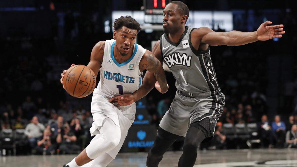 Charlotte Hornets guard Malik Monk, left, drives around Brooklyn Nets guard Theo Pinson during the first half of an NBA basketball game Wednesday, Nov. 20, 2019, in New York. (AP Photo/Kathy Willens)