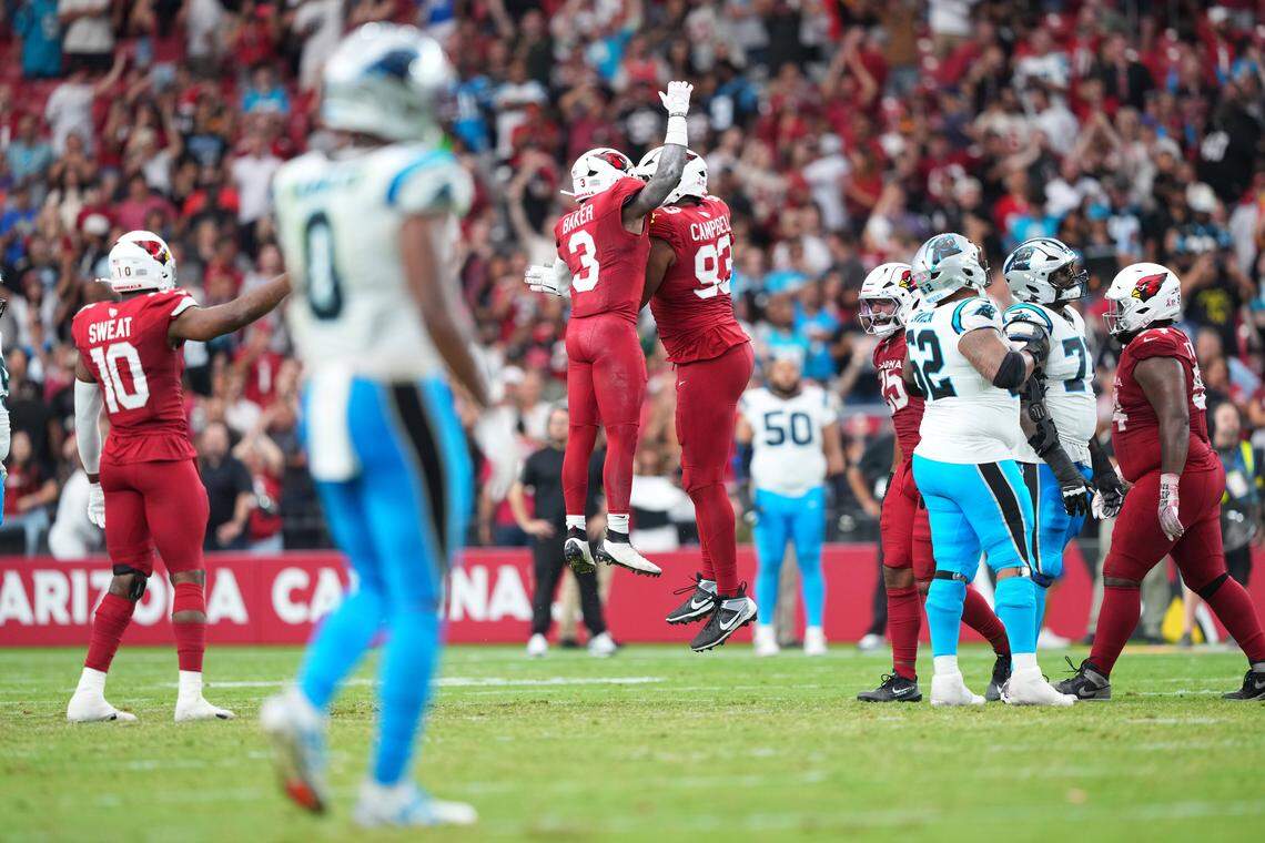 Arizona Cardinals safety Budda Baker (3) and defensive tackle Calais Campbell (93) celebrate Sunday’s win against the Carolina Panthers at State Farm Stadium in Glendale, Ariz. Carolina lost, 27-22, after blowing its last drive.