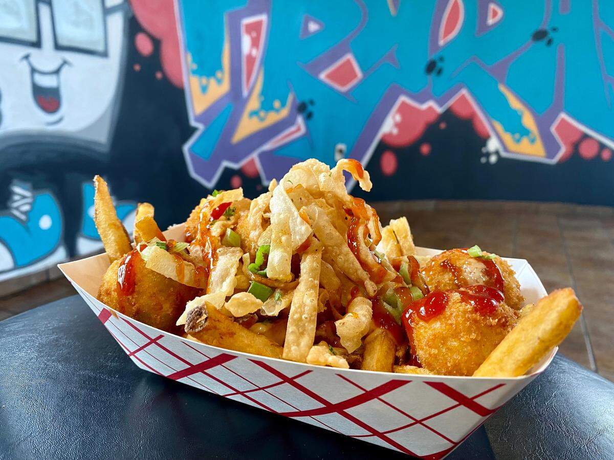 What the Fries’ Crab Rangoon Fries are topped with scratch-made crab rangoon fritters, Yum Yum Sauce, scallions, sweet and sour sauce and crispy wontons ($18).