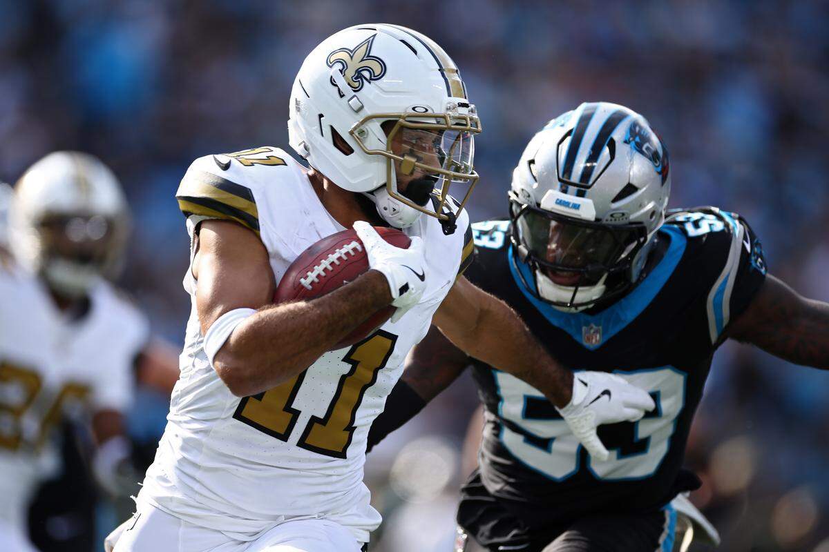 Dante Pettis (11) of the New Orleans Saints returns a punt against Claudin Cherelusof the Carolina Panthers during the first half in the game at Bank of America Stadium on Nov. 9, 2025 in Charlotte, North Carolina.