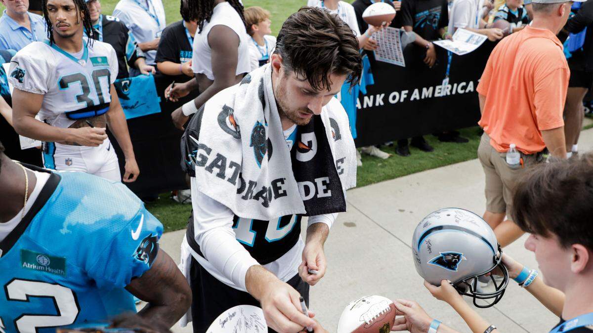 Carolina Panthers quarterback, Jake Luton, signs autographs with fans after a practice at Wofford College in Spartanburg on Saturday, July 29, 2023. 