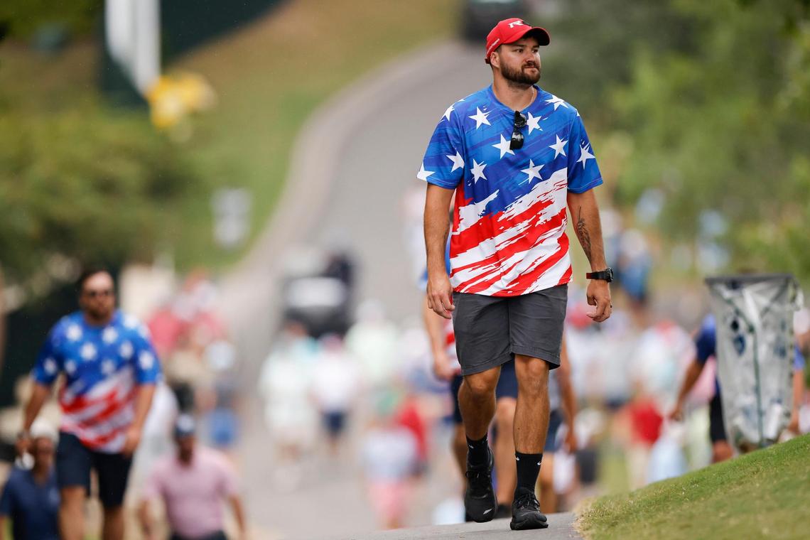 A spectator walks along a cart path during the Presidents Cup golf tournament at the Quail Hollow Club in Charlotte, N.C., Thursday, Sept. 22, 2022.