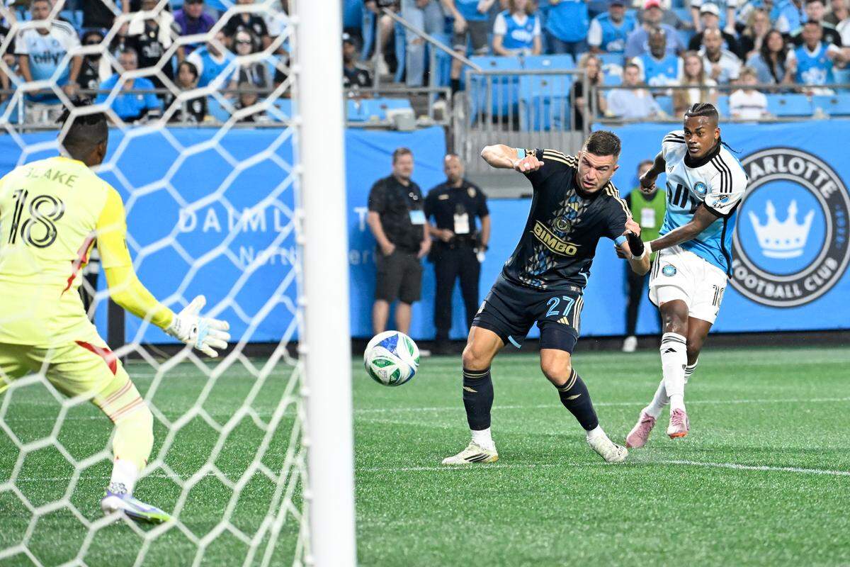 Charlotte FC forward Kerwin Vargas (18) scores as Philadelphia Union goalkeeper Andre Blake (18) and defender Kai Wagner (27) defend in the first half at Bank of America Stadium. 