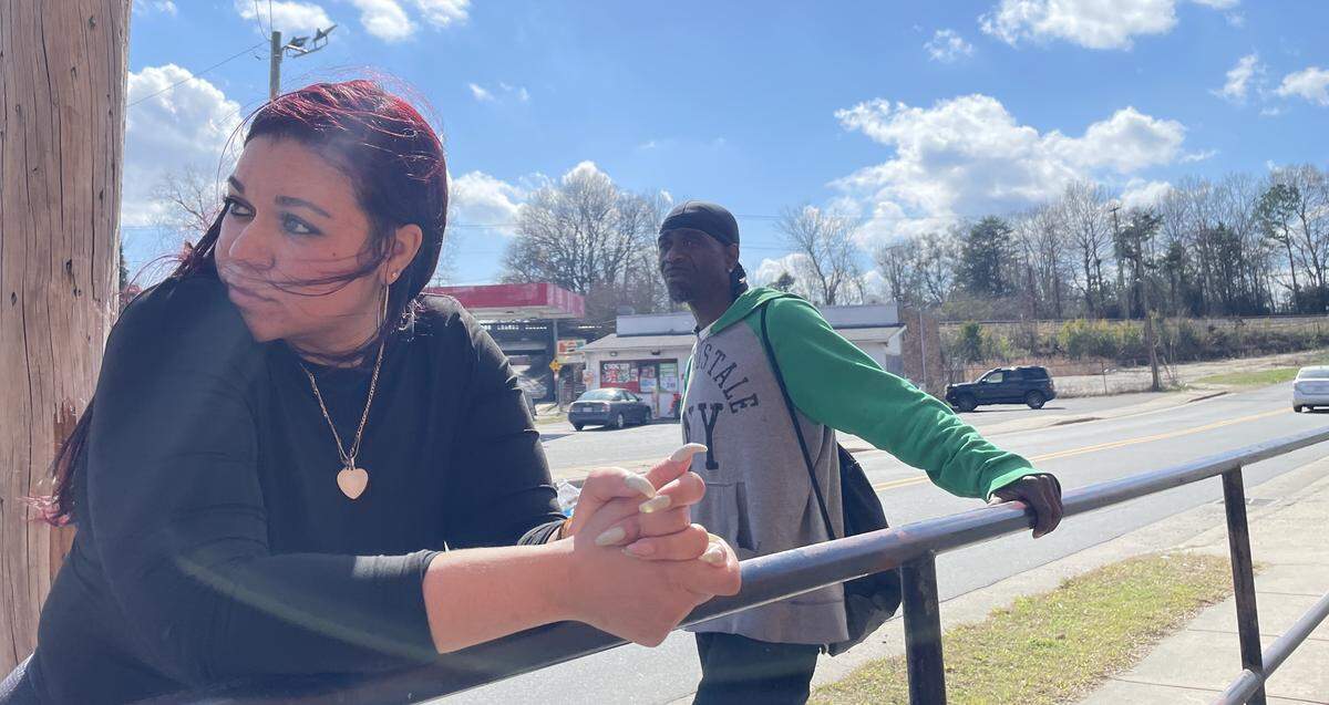 Olivia Henderson introduces a Charlotte Observer reporter to Robert Springs, a man who says he saw police shoot at her uncle, Derrick Manigault.