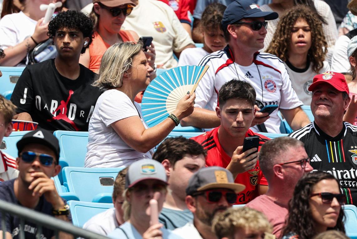 A spectator fans herself to keep cool during the match between S.L. Benfica and Bayern München during the FIFA Club World Cup at Bank of America Stadium in Charlotte, NC on Tuesday, June 24, 2025.