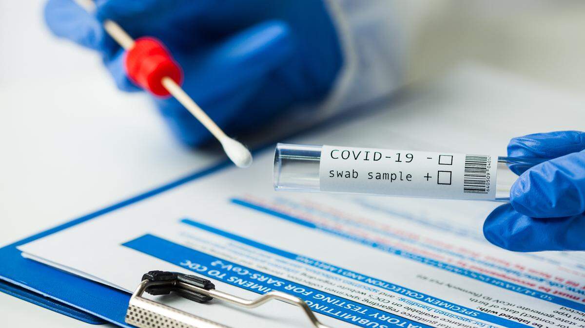 A medical worker holds a coronavirus COVID-19 NP OP swab sample test kit and nasal collection equipment. The CDC estimates that 140 million Americans have had the coronavirus.