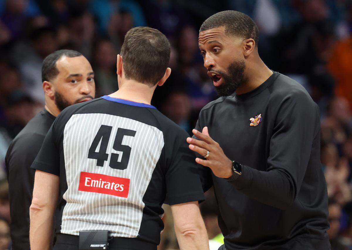Charlotte Hornets head coach Charles Lee, right, speaks with referee Brian Forte during action against the Detroit Pistons on Friday, April 10, 2026 at Spectrum Center in Charlotte, North Carolina. 