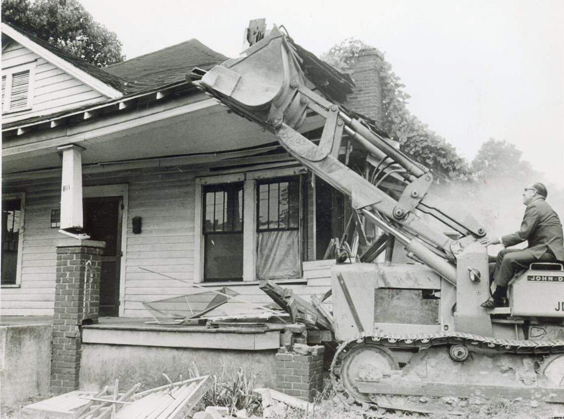 February 1970: A bulldozer pushes over the first house in Brooklyn, an old Charlotte neighborhood, to make way for urban renewal.