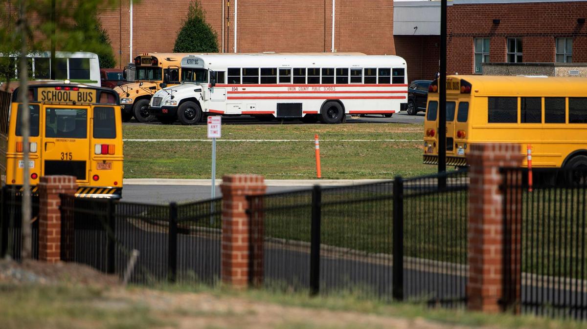 A Union County activity bus is seen as school buses arrive to pick up students at the end of the school day at Sun Valley High School on Sept. 13, 2021 in Monroe.