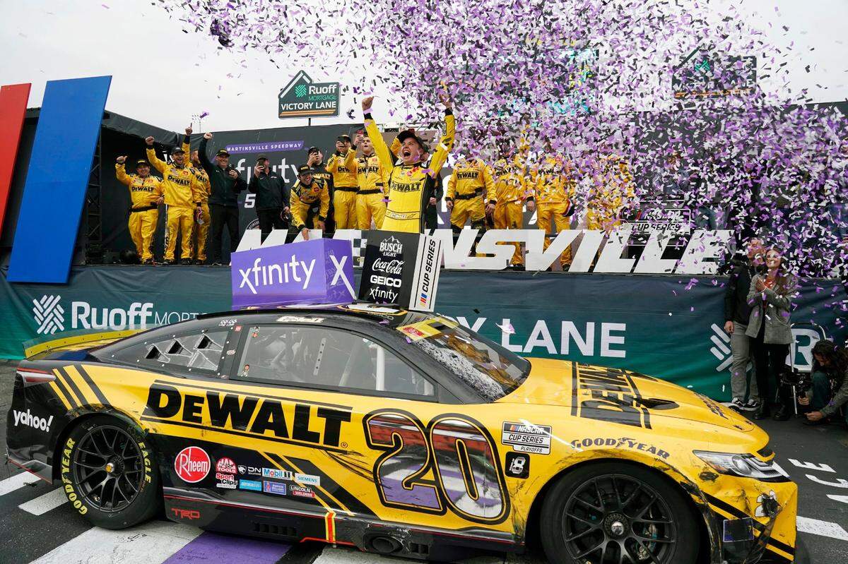 Christopher Bell (20) celebrates in Victory Lane after winning a NASCAR Cup Series auto race at Martinsville Speedway, Sunday, Oct. 30, 2022, in Martinsville, Va. (AP Photo/Chuck Burton)