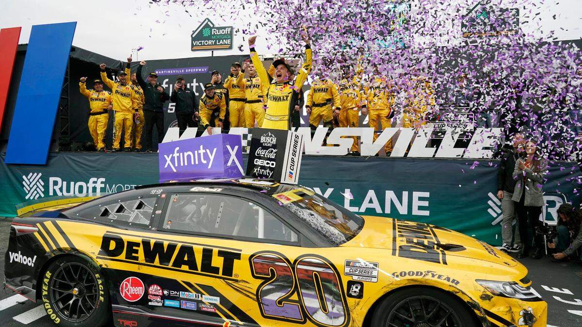 Christopher Bell (20) celebrates in Victory Lane after winning a NASCAR Cup Series auto race at Martinsville Speedway, Sunday, Oct. 30, 2022, in Martinsville, Va. (AP Photo/Chuck Burton)
