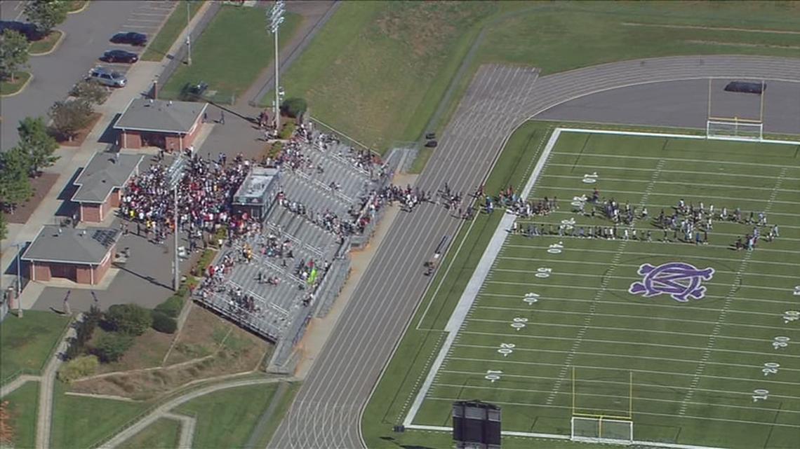 A photo from the WSOC helicopter shows students at Cox Mill High School in Concord, NC, at the football stadium after a bomb threat at the Cabarrus County campus on Tuesday, September 20, 2022.