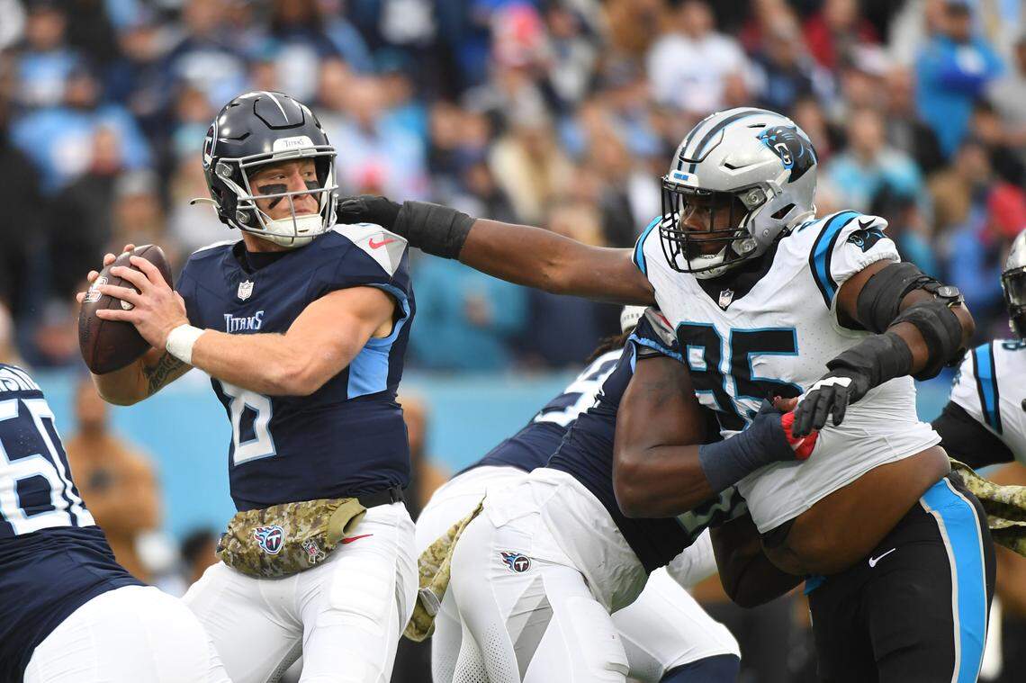 Nov 26, 2023; Nashville, Tennessee, USA; Tennessee Titans quarterback Will Levis (8) stands in the pocket as he is pressured by Carolina Panthers defensive tackle Derrick Brown (95) during the first half at Nissan Stadium. Mandatory Credit: Christopher Hanewinckel-USA TODAY Sports