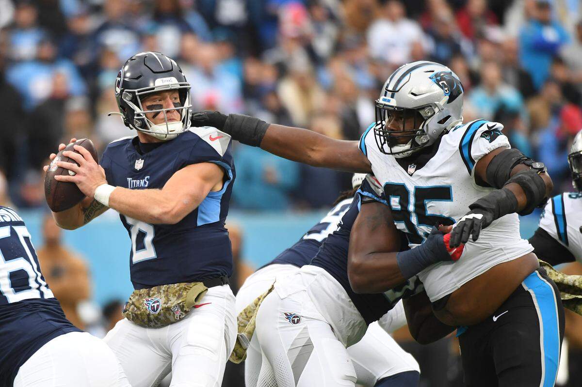 Nov 26, 2023; Nashville, Tennessee, USA; Tennessee Titans quarterback Will Levis (8) stands in the pocket as he is pressured by Carolina Panthers defensive tackle Derrick Brown (95) during the first half at Nissan Stadium. Mandatory Credit: Christopher Hanewinckel-USA TODAY Sports