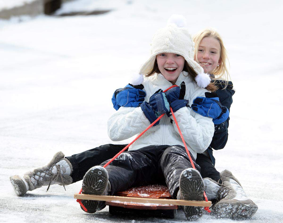 Lindsay Pearce, 11, left, and Carson Weber, 10, sled at the hill at the corner of Sedley and Foxcroft Roads where the icy conditions made for great sledding in January 2014