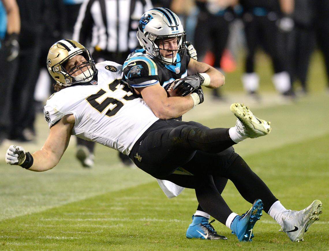 Carolina Panthers running back Christian McCaffrey fights to maintain control of the ball while being tackled by New Orleans Saints linebacker A.J. Klein (53) during the third quarter at Bank of America Stadium in Charlotte, N.C., on Monday, Dec. 17, 2018. The Saints won, 12-9. (Jeff Siner/Charlotte Observer/TNS)