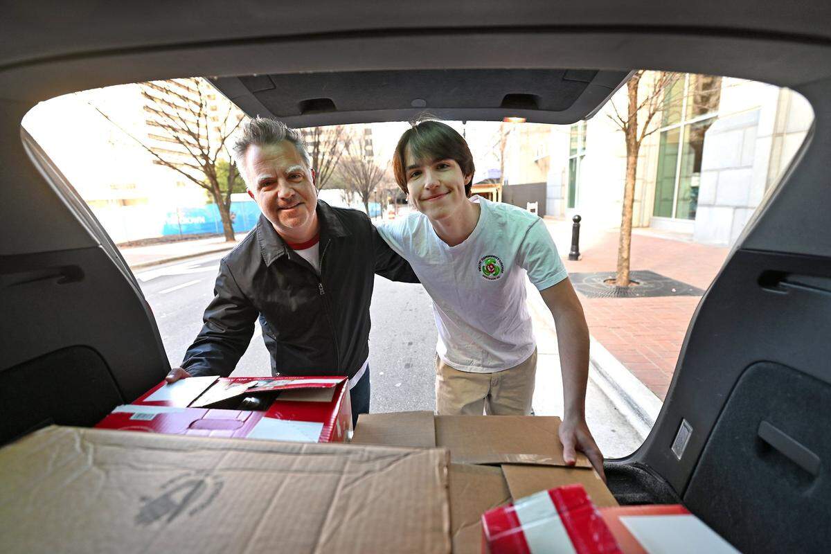 Brendan Kelly and his son Liam, photographed while making a food pickup in Charlotte last month.