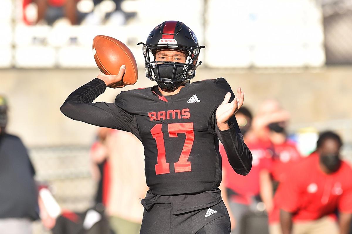 Rolesville’s Byrum Brown (17) looks to pass during the first quarter. The Wake Forest Cougars and the Rolesville Rams met in a NCHSAA 4AA Regional Round football game in Rolesville, N.C. on April 20, 2021.