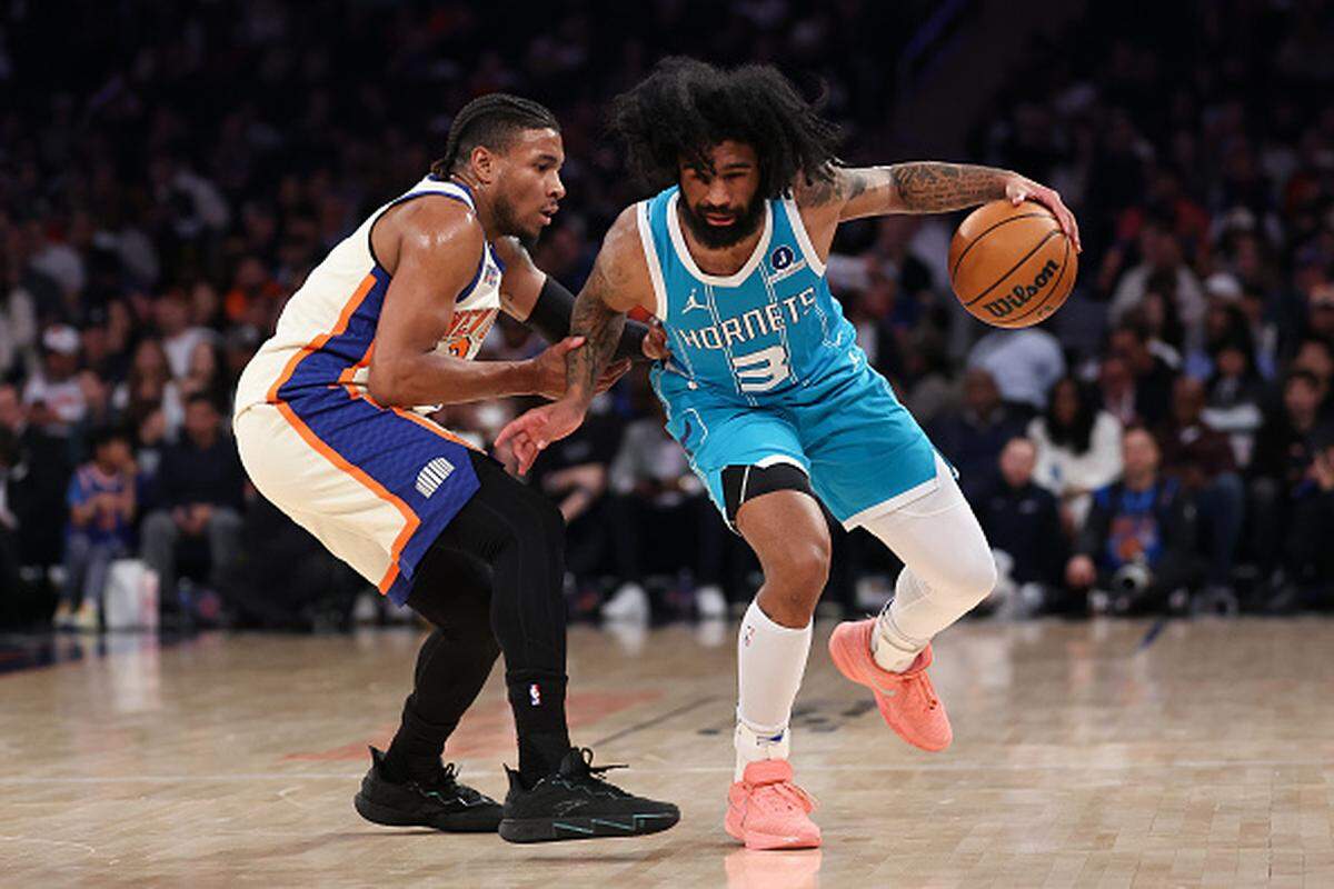 Coby White of the Charlotte Hornets controls the ball against Miles McBride of the New York Knicks during the first half at Madison Square Garden.