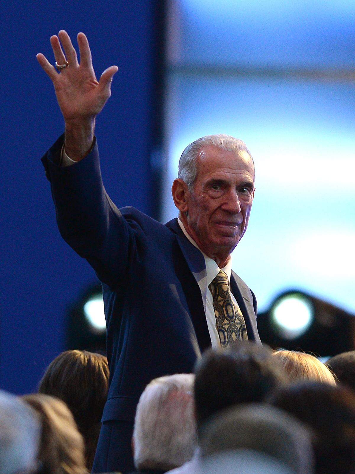 Former NASCAR driver and Hall of Fame member Ned Jarrett waves to the audience after being introduced during the NASCAR Hall of Fame Induction Ceremony on Saturday, January 23, 2016. 