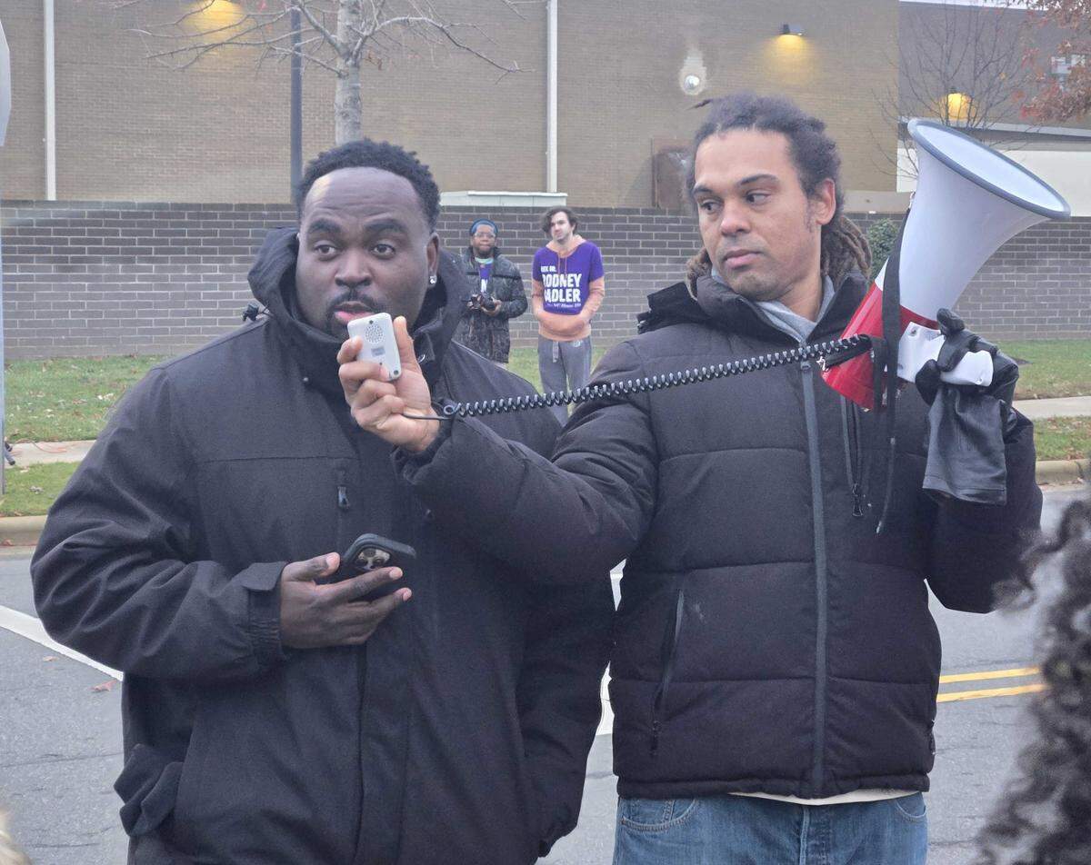 Corning employee Shamaal Thomas, left, and Braxton Winston, president of the North Carolina AFL CIO, make remarks during the rally.