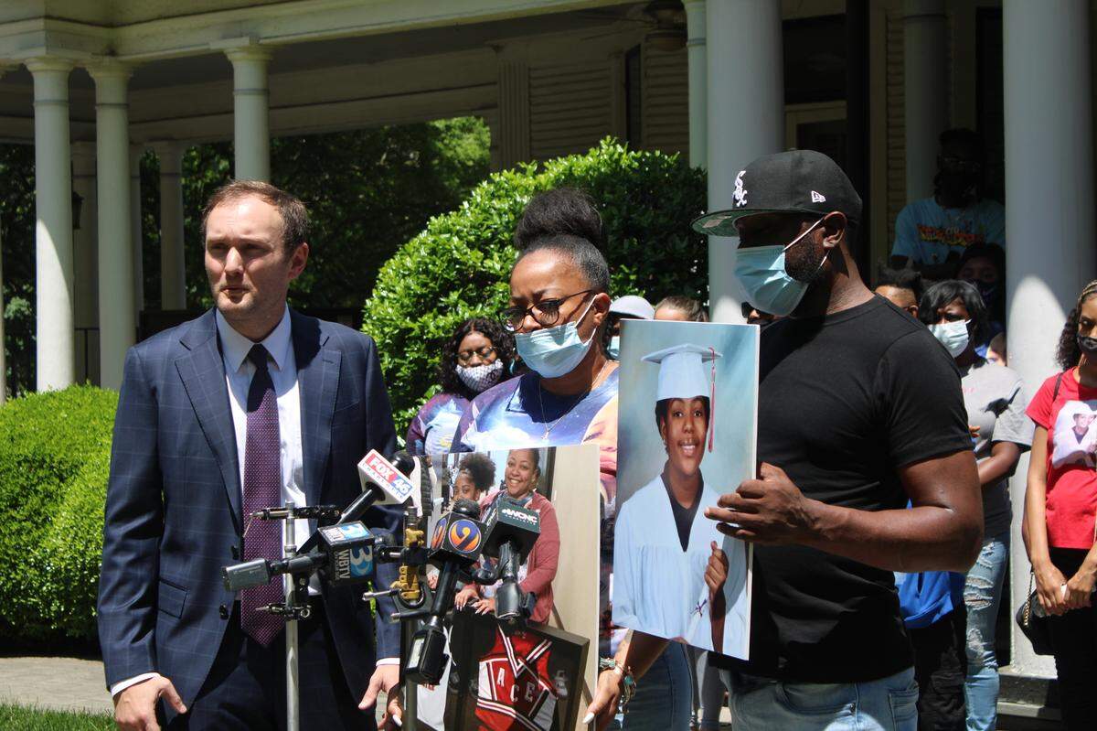 Daniale Mackin, middle, and Omar Propst, right, are joined by their lawyer, Brian Mickelsen on Wednesday, May 5, 2021, as they discuss a lawsuit over the 2019 shooting death of daughter Aveanna Propst. The 13-year-old was caught in the crossfire in a Concord Mills parking lot.